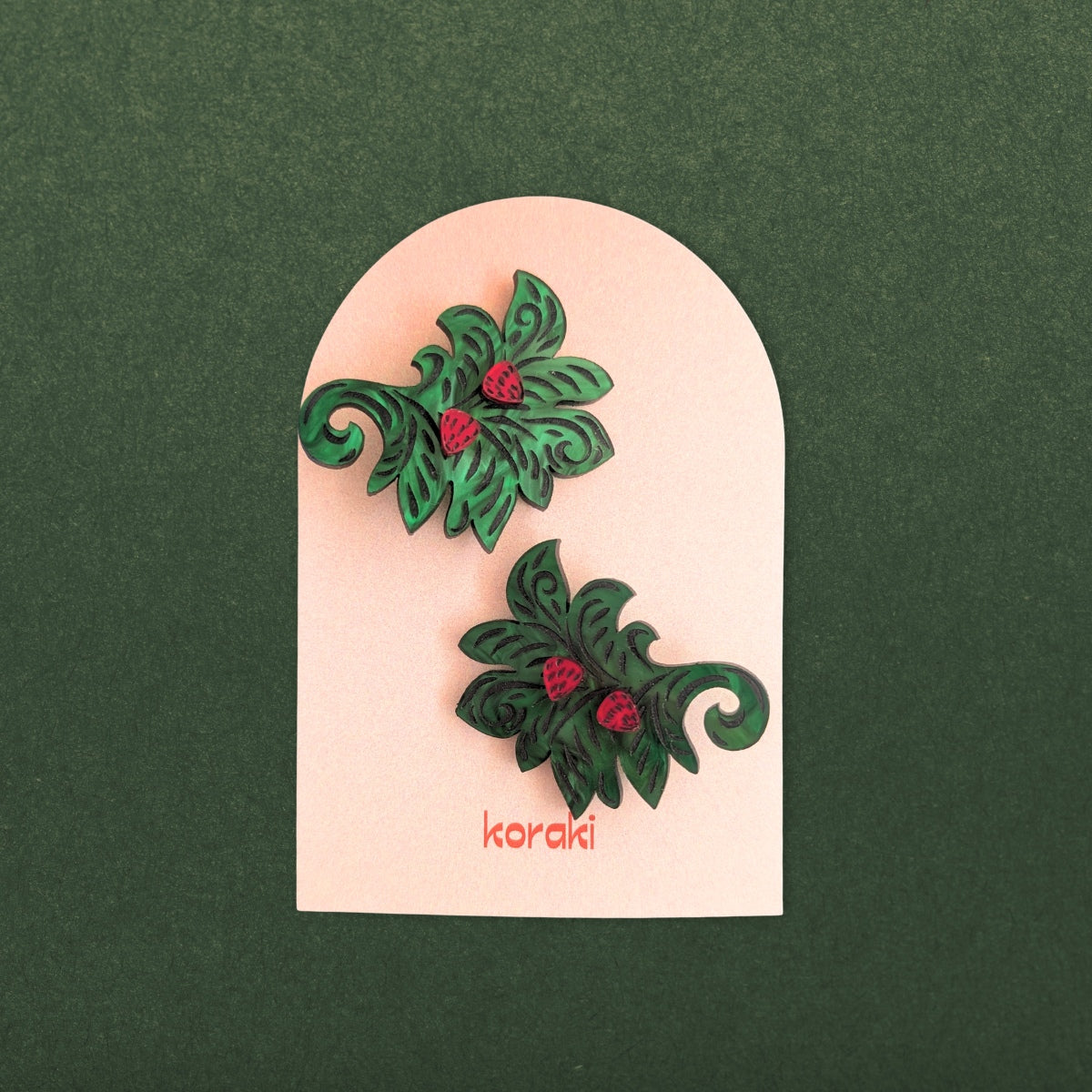 Green leaves with mini strawberries hair clips on branded card